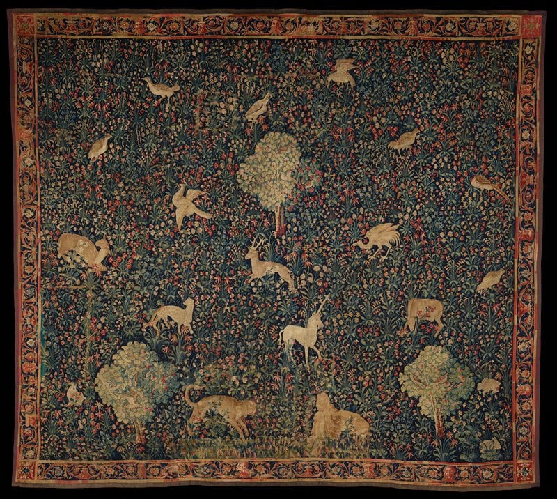 tapestry with animals on a background full of flowers