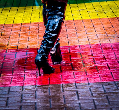 Black boots on a colorful pavement