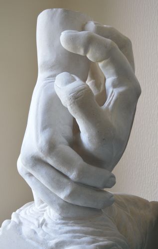 stone sculpture of clasping hands