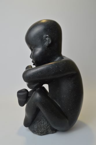 limestone sculpture of a small child