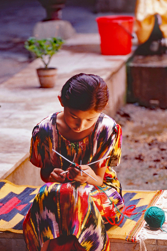 Photo of an Uzbek girl knitting 
