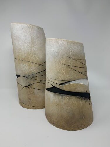 two multi-colored handbuilt ceramic vessels