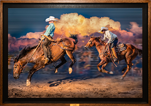 two cowboys riding bucking horses