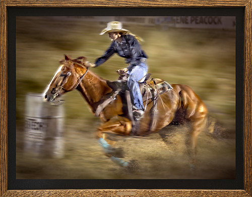 photo of a cowgirl barrel racing