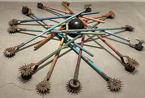 futuristic nest art made with lawn edgers and bowling ball