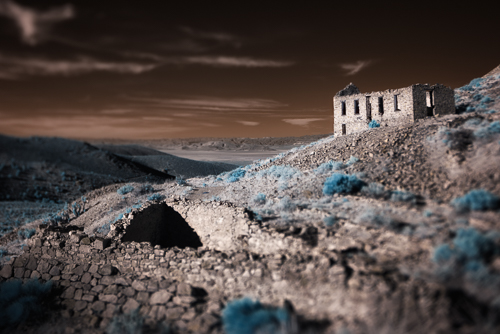 night photograph of a house in an abandoned ghost town