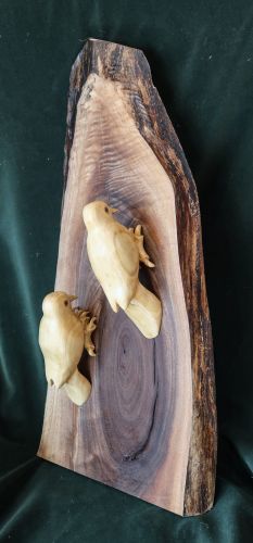 wooden sculpture of downy woodpeckers