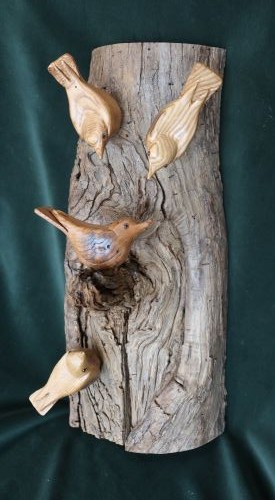 wooden sculpture of nuthatches on a tree