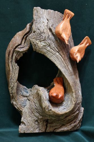 wooden sculpture of nutches on a tree