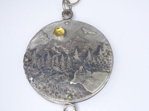 "a day in the forest" multiple layers of hand pierced, sawn, fused, burr/hammer textured argentium silver, bezel set 6mm citrine, patina, hand pierced and riveted argentium silver moose in the mountains on reverse side, 2” diameter