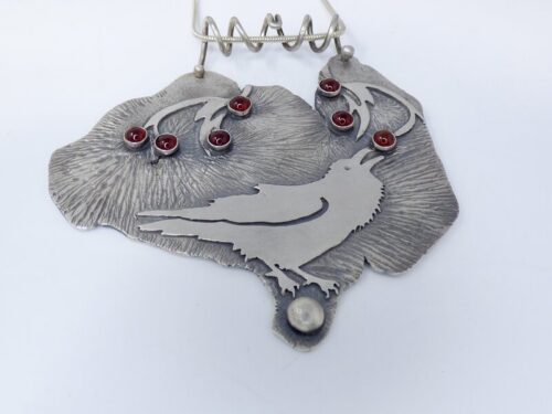 handmade silver pendant with raven design