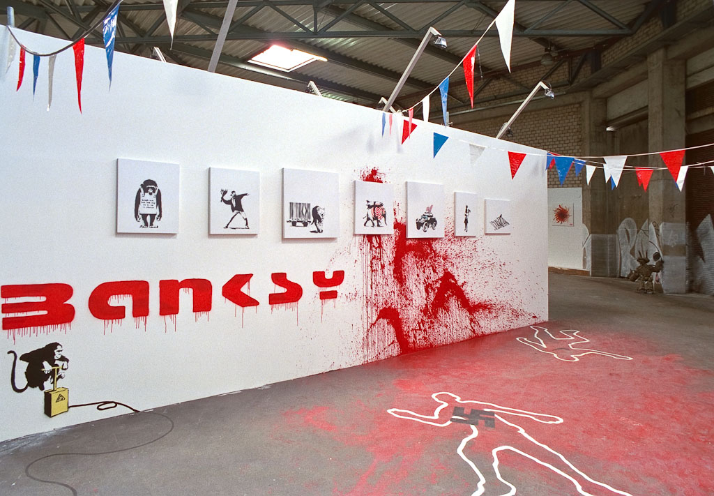 Banksy display at Urban Discipline Hamburg with bunting, small works and paint on the floor
