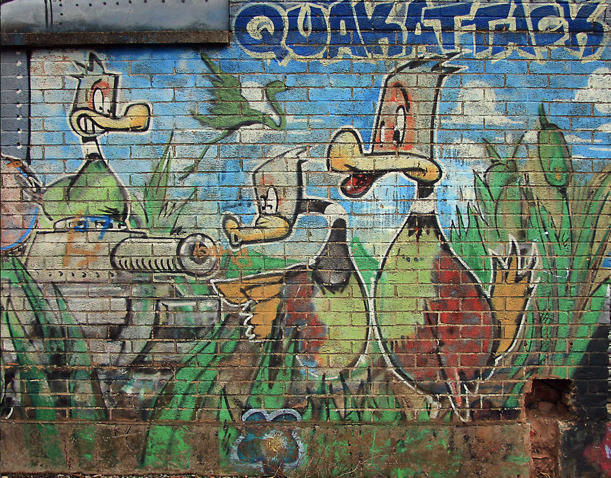 Banksy Quakattack duck characters painted on a Bristol brick wall