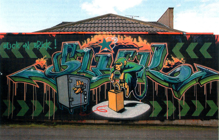 Banksy Slick freehand mural with lettering, a monkey and a safe in Bristol