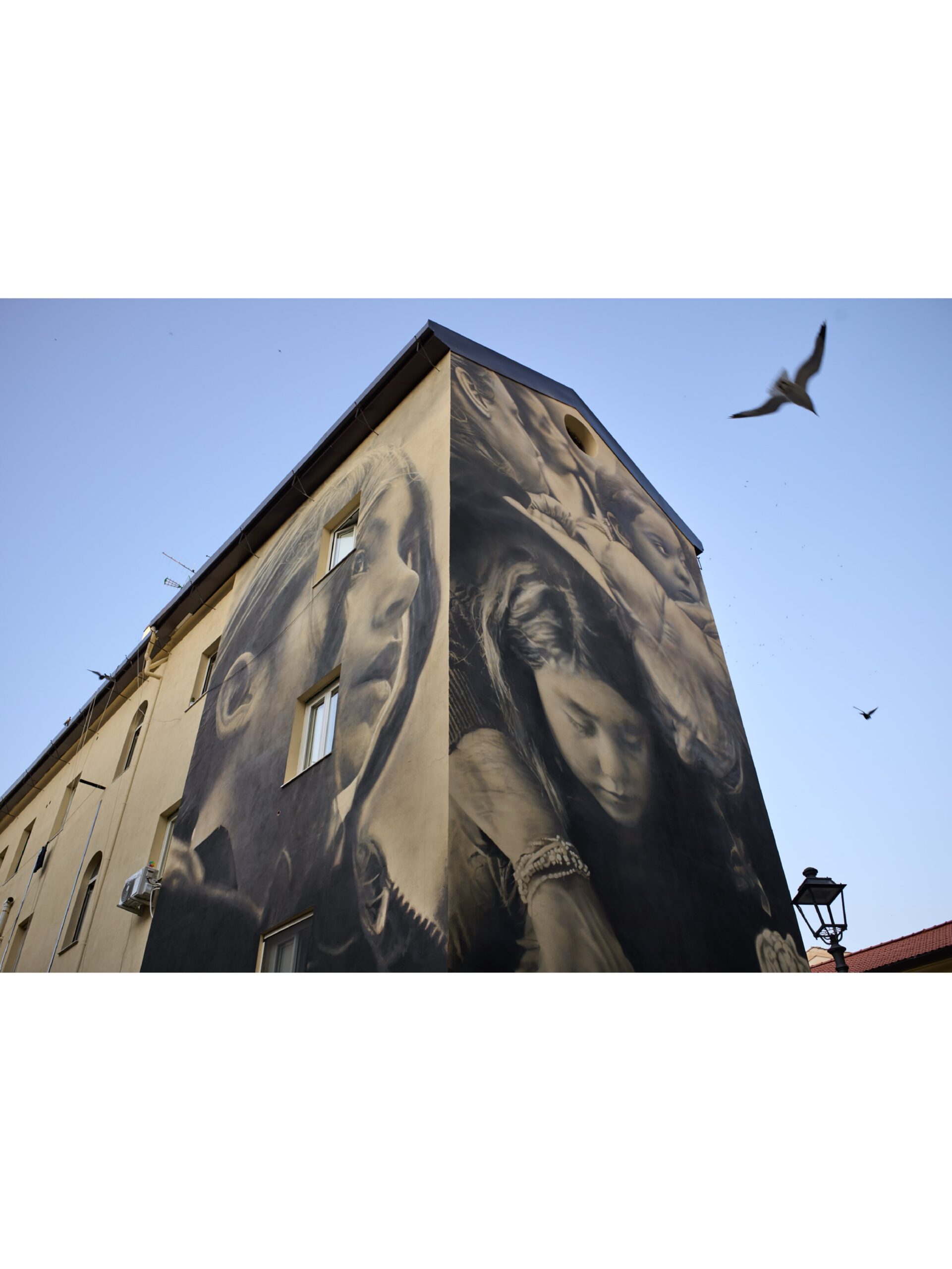 Photo by Guido van Helten on October 01, 2026. May be an image of buildings and text.